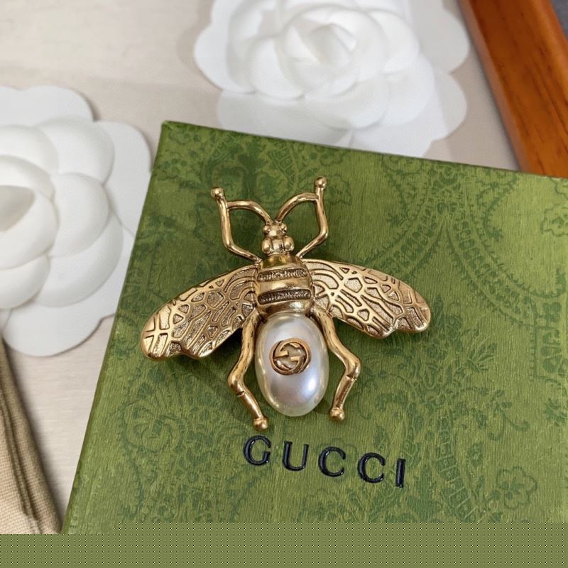 G*u*i brooches
